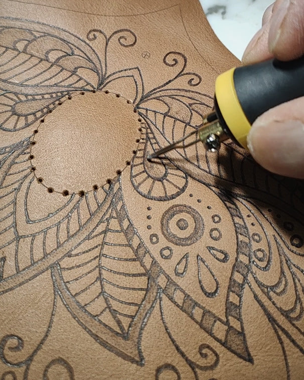 Close-up of artisan leather belt bag process by Bohonito, featuring detailed hand-crafted henna pyrography being burned into premium Natural oiled leather.