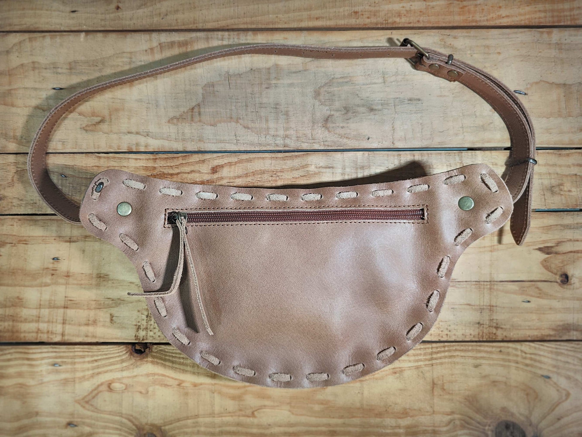 Rear view of Bohonito belt bag  showing the zipper pocket and interchangeable flap system for the kirtmukha tiger eye design.