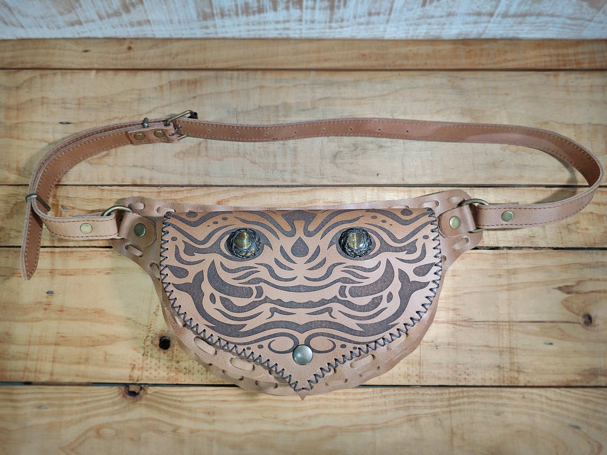 Bohonito belt bag with kirtmukha engraved detailing and tiger eye on its interchangeable flap.