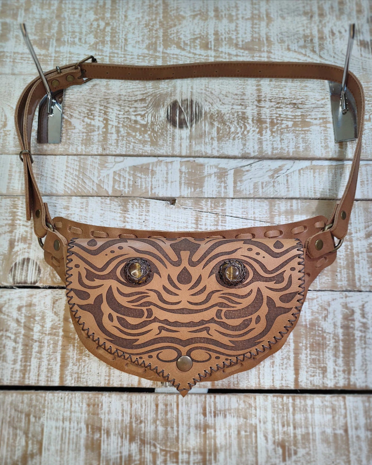 Handcrafted Bohonito leather belt bag featuring an engraved kirtmukha guardian and protective tiger eye side stones.