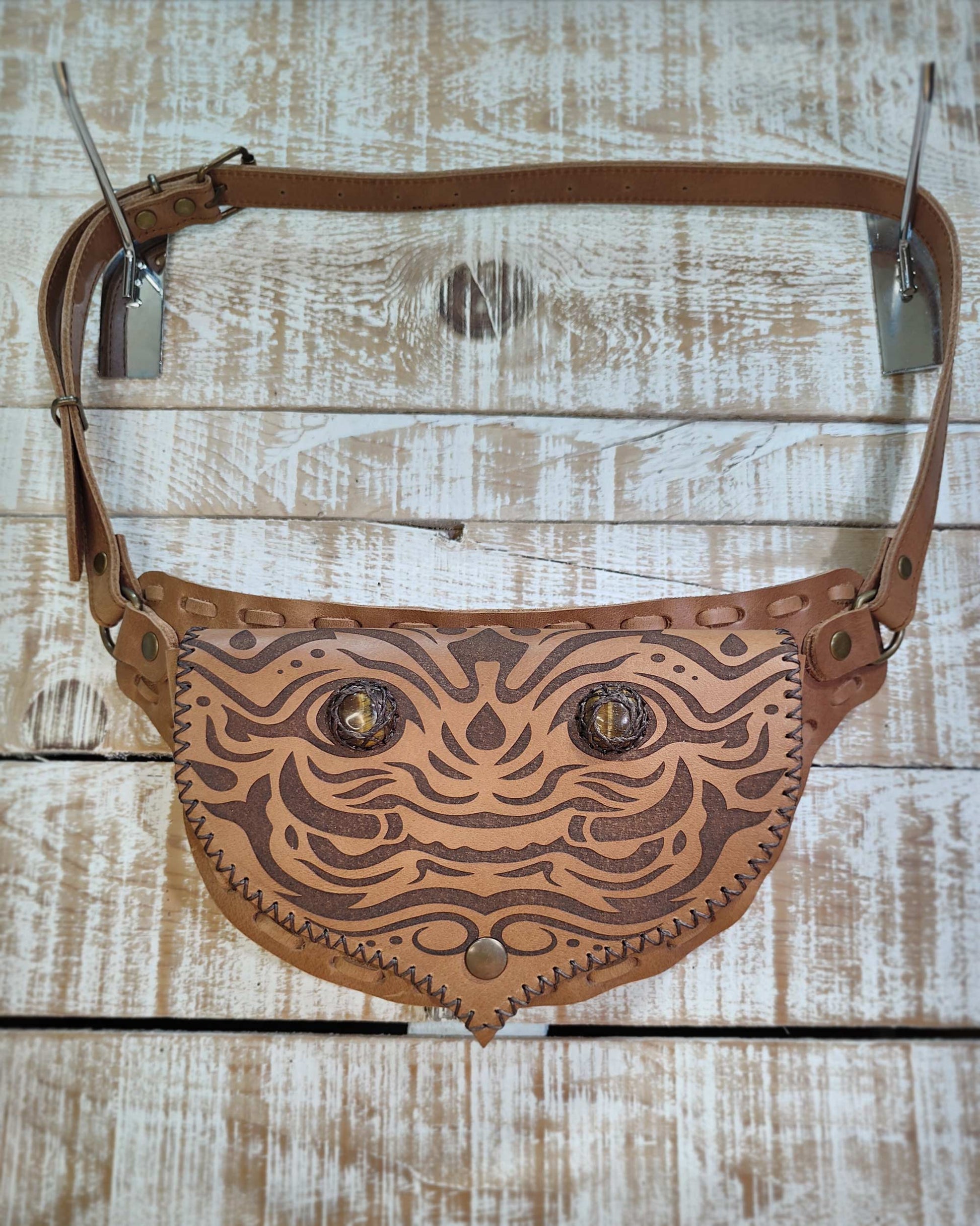 Handcrafted Bohonito leather belt bag featuring an engraved kirtmukha guardian and protective tiger eye side stones.