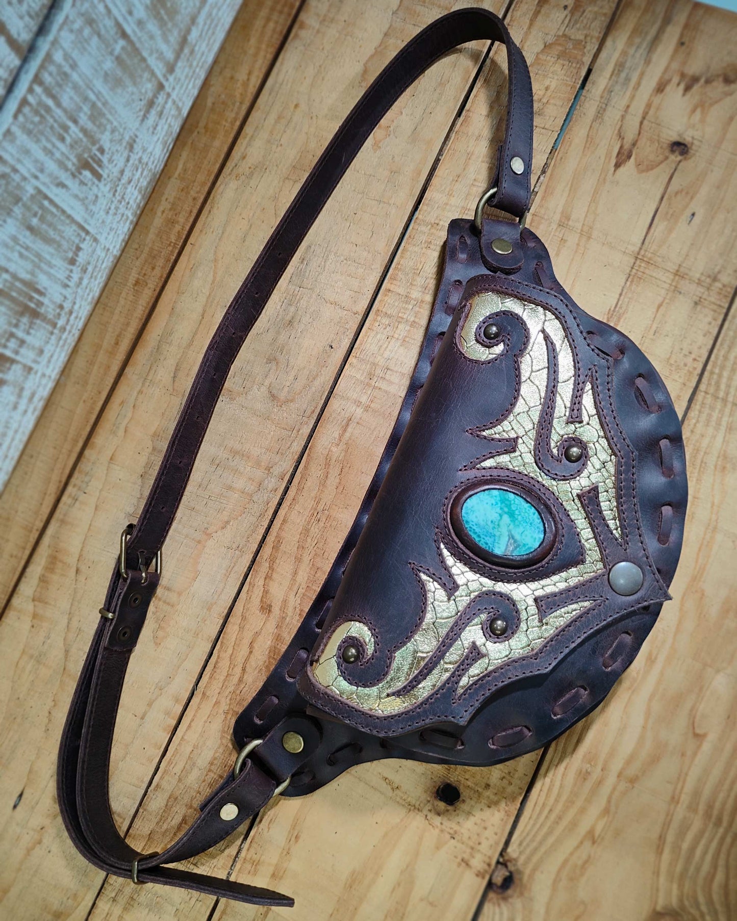 Handmade Bohonito brown leather belt bag with a tribal design and natural snake skin agate.
