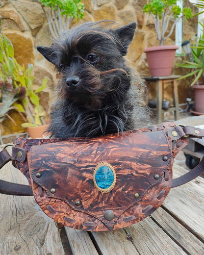 Handmade Bohonito brown stamped leather belt bag with hand-painted Caos design and blue apatite.