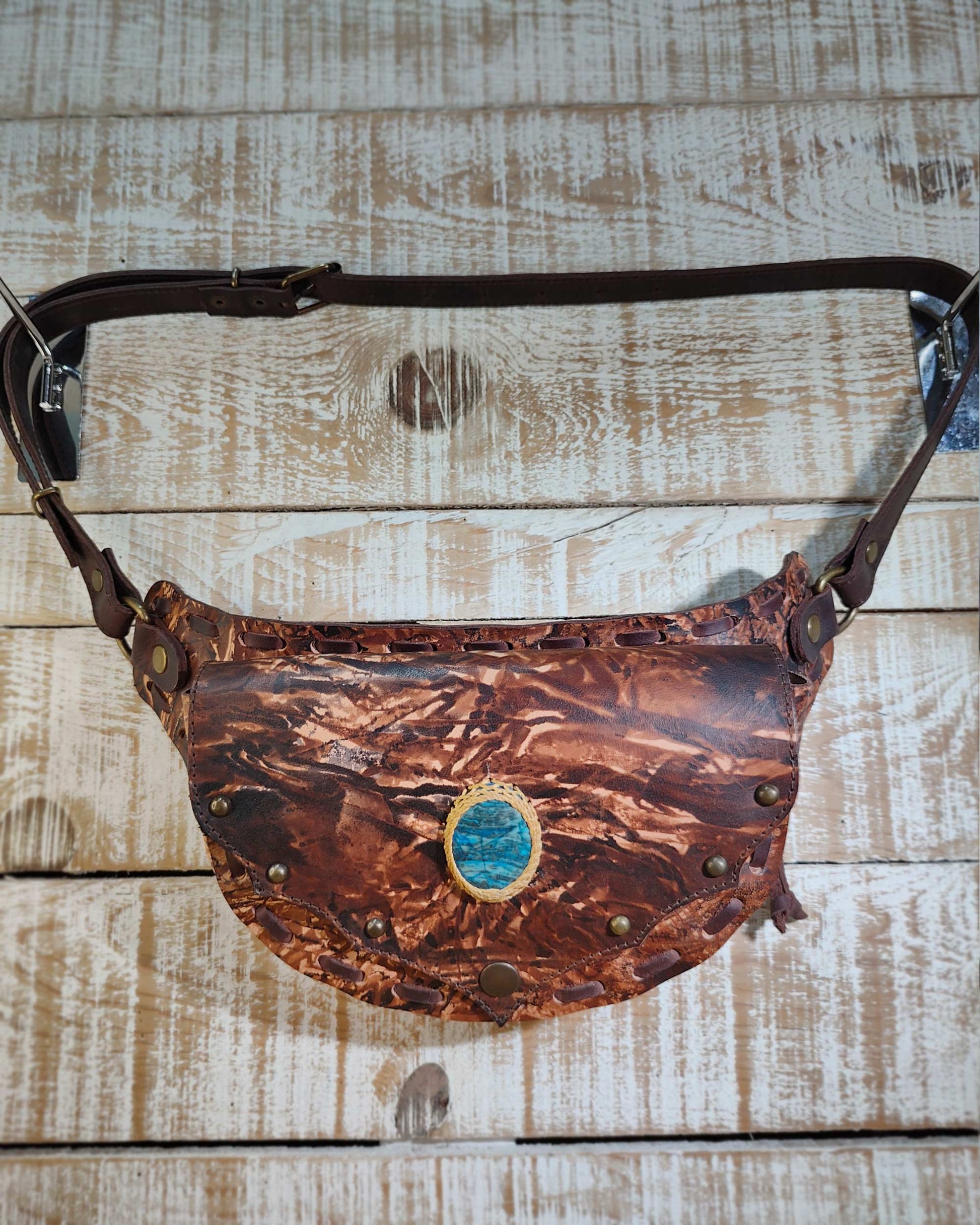 Bohonito brown leather belt bag with hand-painted artwork and a natural apatite healing gemstone.