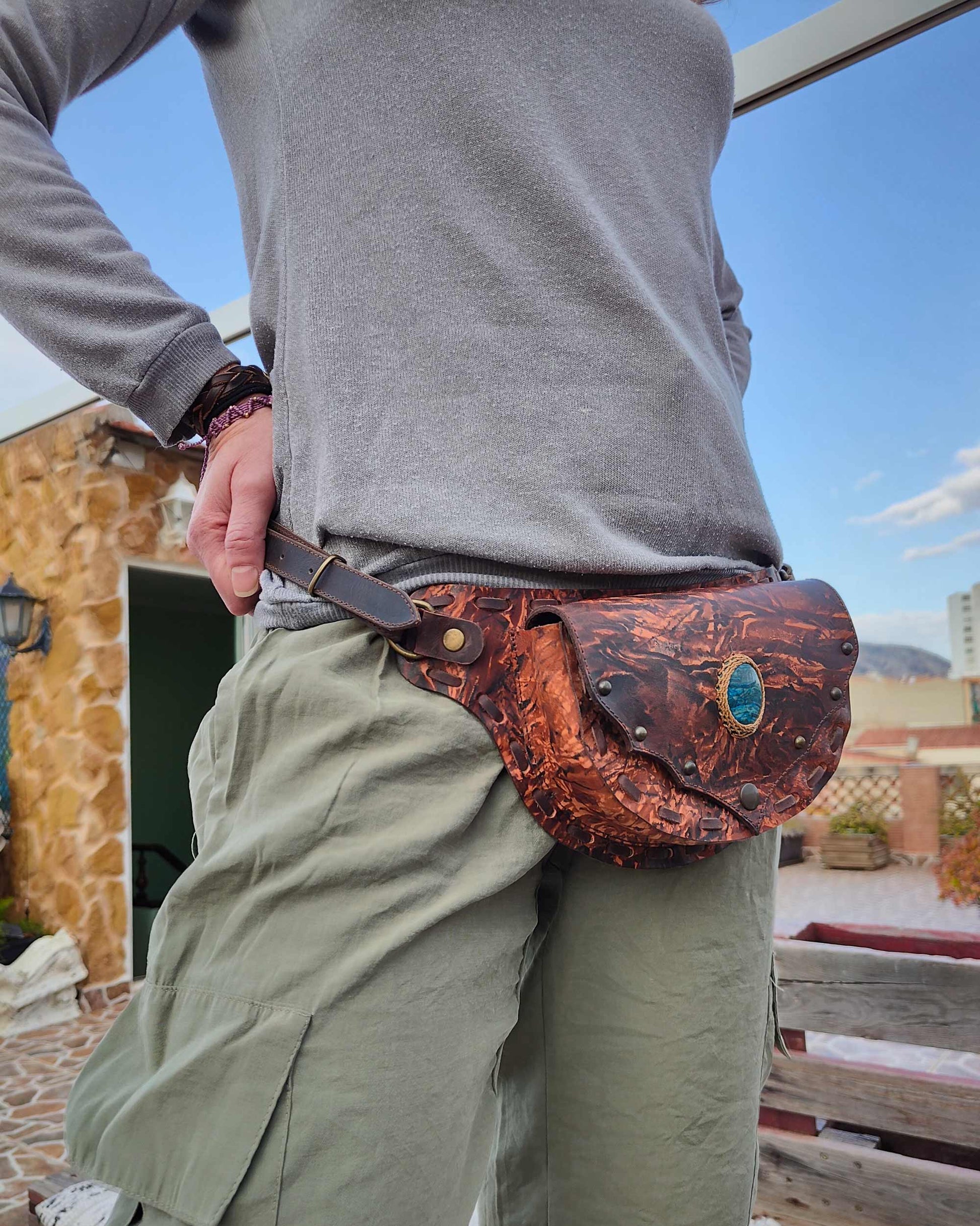 Handmade Bohonito brown stamped leather mini Gautxa belt bag with hand-painted Caos design and blue apatite.