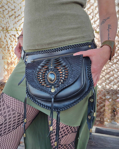 Close-up of artisan leather belt bag by Bohonito, featuring the detailed interchangeable Kobra flap design and macrame-wrapped obsidian.
