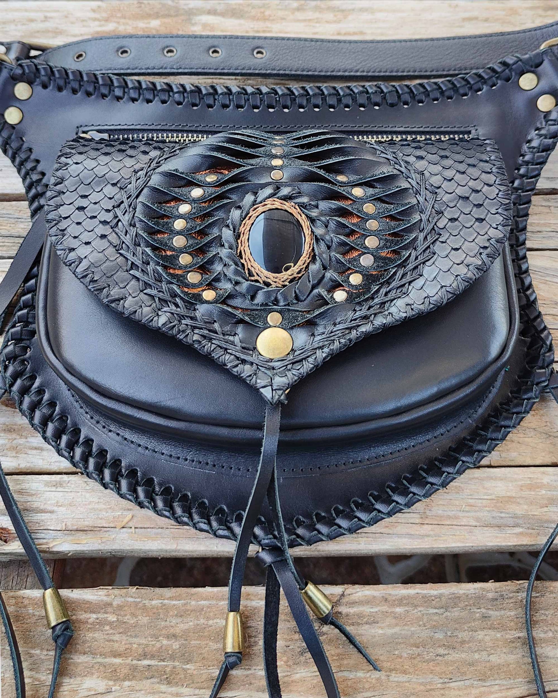 Artisan leather belt bag by Bohonito, featuring hand-modeled leather feathers and fluid tassels on premium Black Boxcalf leather with Obsidian stone.