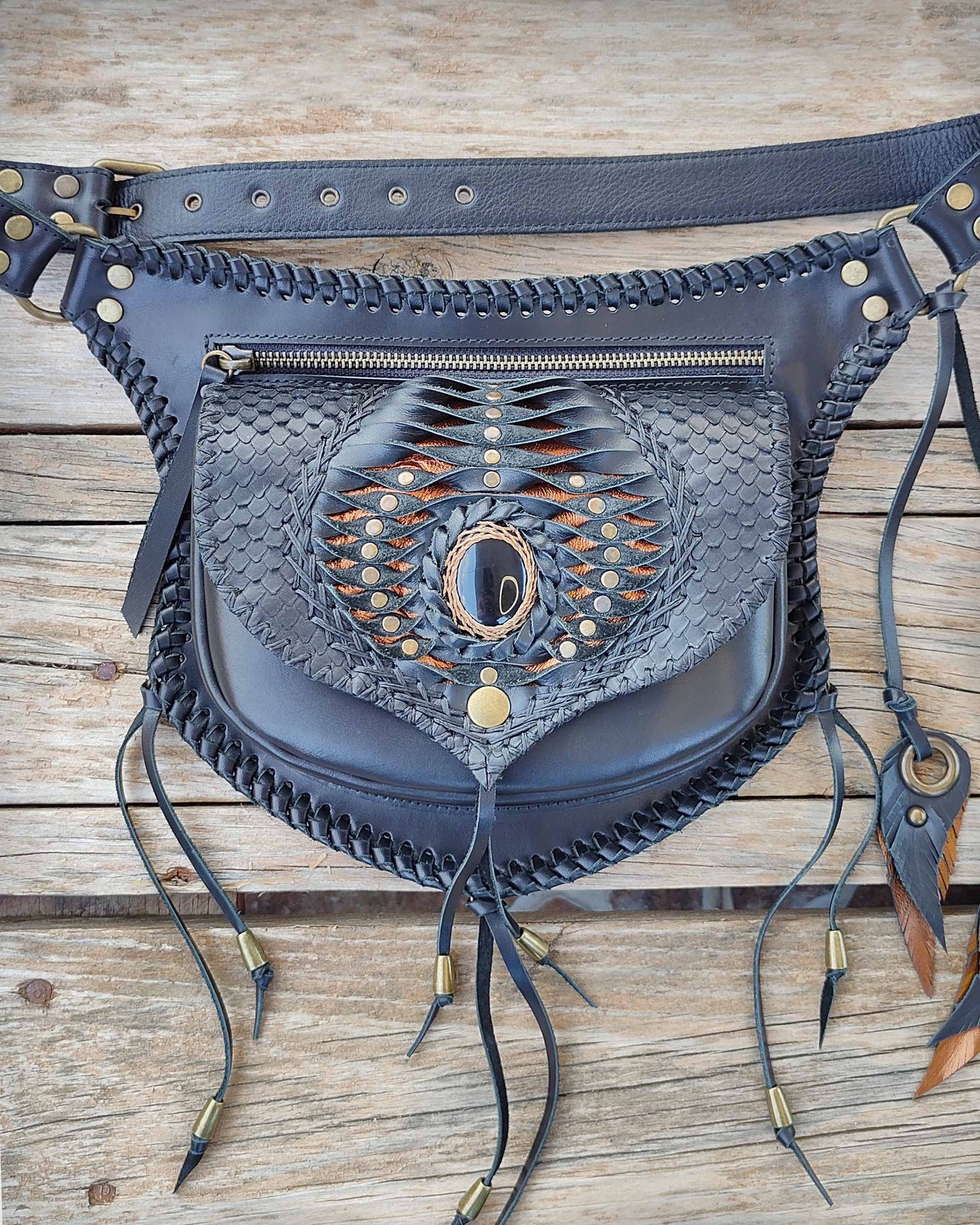 Artisan leather belt bag by Bohonito, featuring a versatile interchangeable Kobra flap design with hand-modeled leather feathers, edge lacing and Obsidian stone.