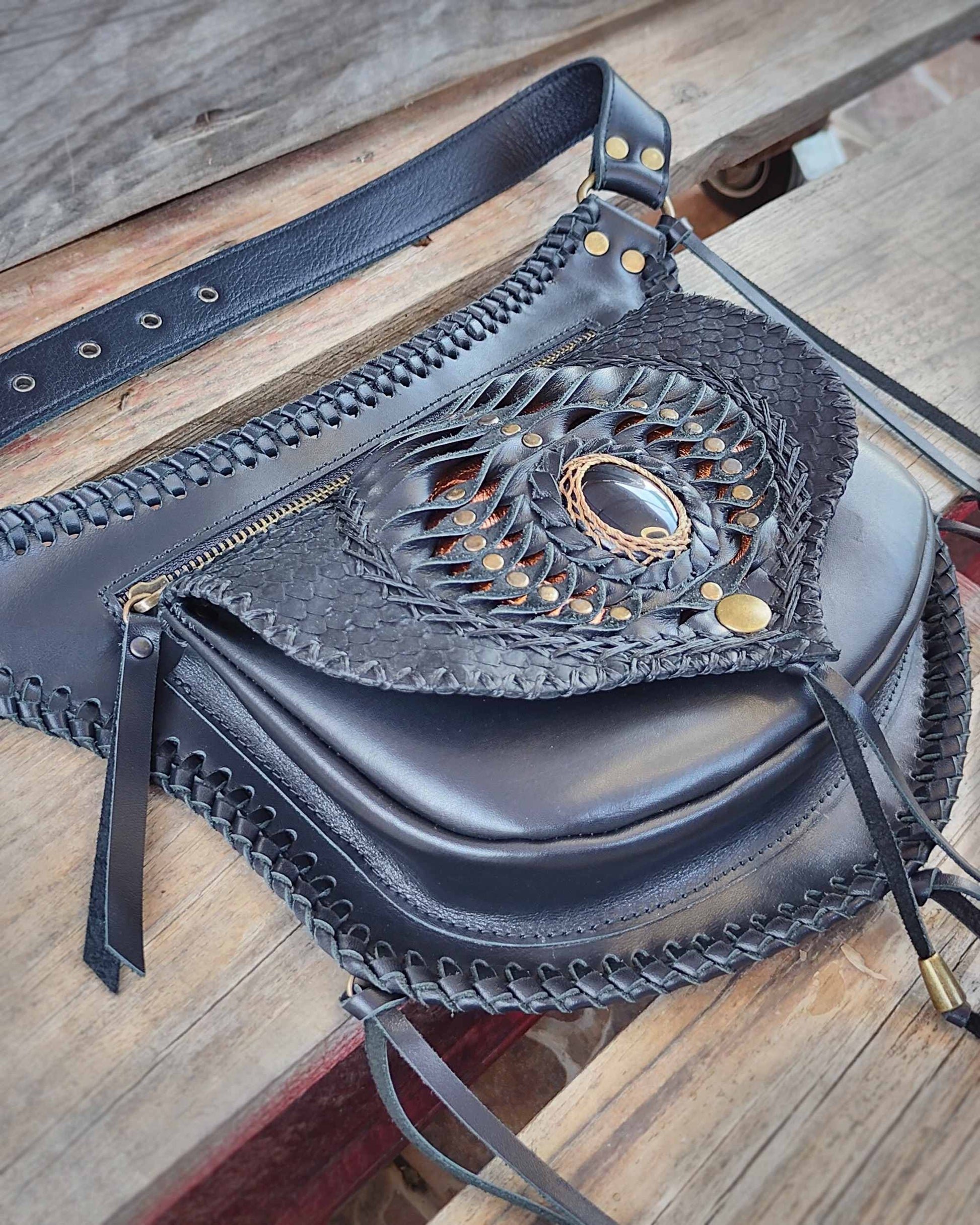 Artisan leather belt bag by Bohonito, featuring the innovative system of interchangeable flaps on premium Black Boxcalf leather, edge lacing and Obsidian stone.