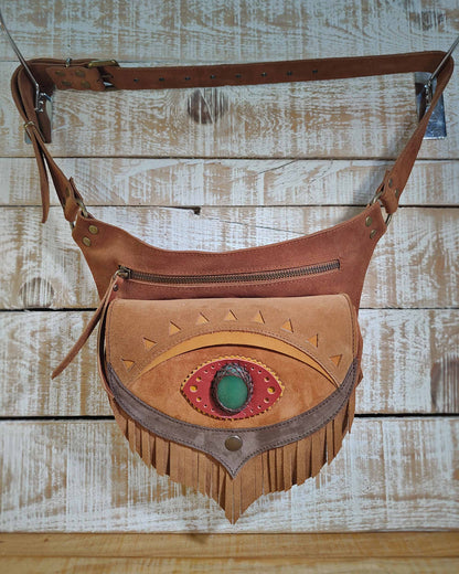 Handcrafted leather belt bag in brown and honey tones, decorated with a third eye Ajna chakra detail and natural aventurine inlay.
