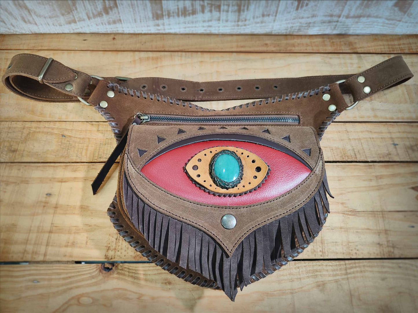Omara brown leather waist bag with a fringed red flap, aventurine inlay, and decorative hand-laced borders.