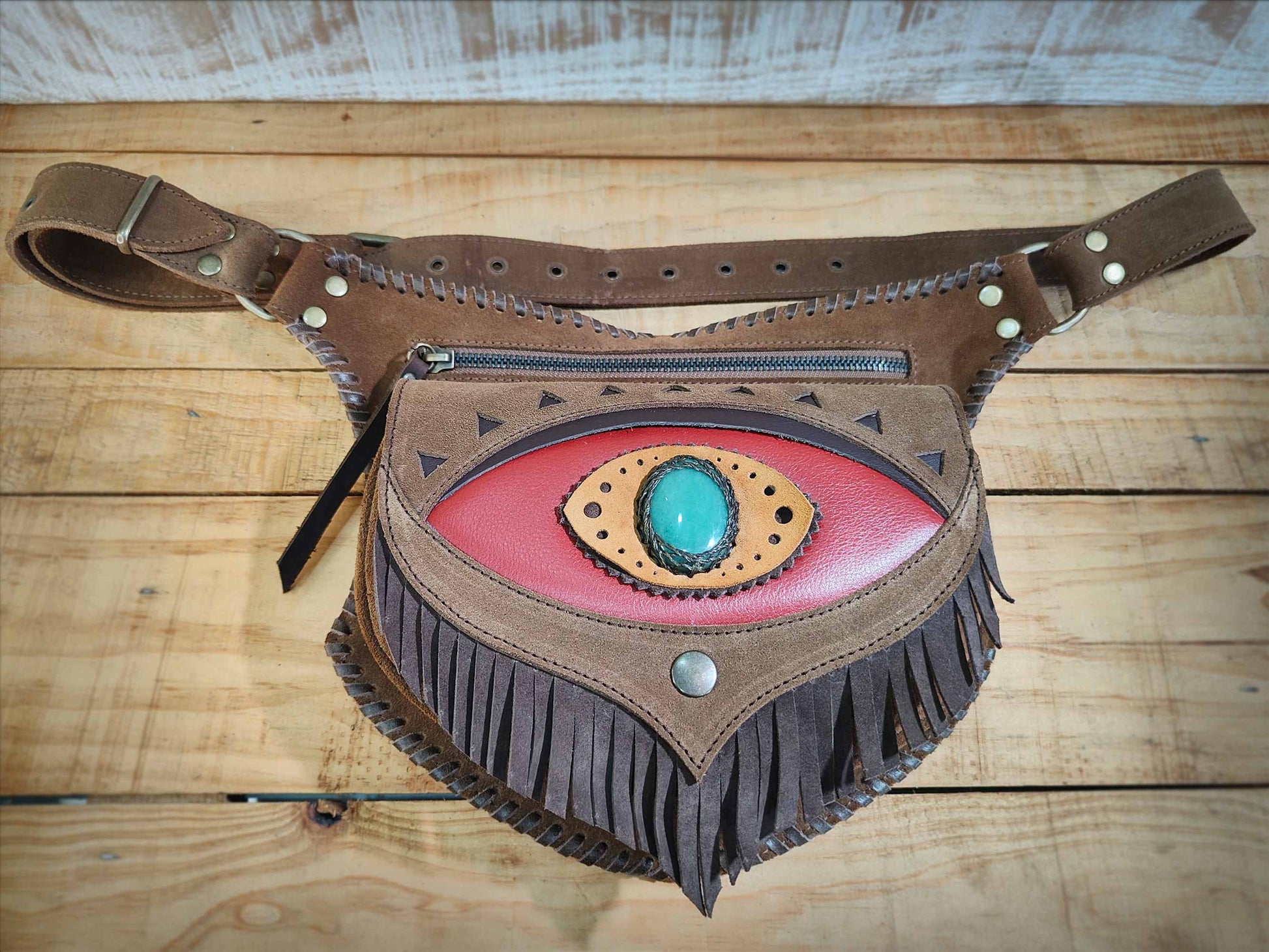 Omara brown leather waist bag with a fringed red flap, aventurine inlay, and decorative hand-laced borders.