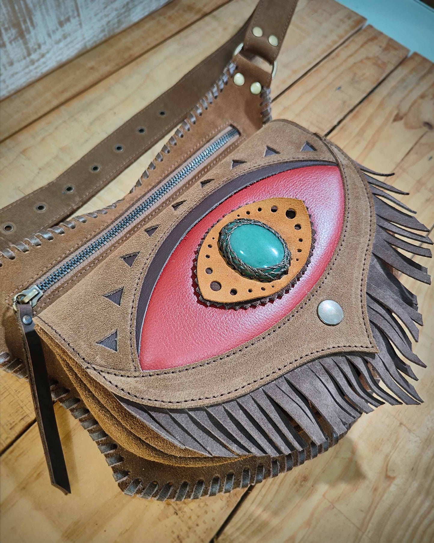 Bohonito festival belt bag with a red flap and fringes, Ajna eye symbol with aventurine stone and hand-laced leather thonging.
