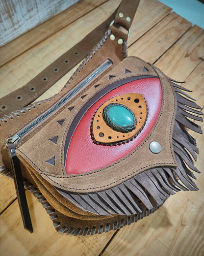 Bohonito festival belt bag with a red flap and fringes, Ajna eye symbol with aventurine stone and hand-laced leather thonging.