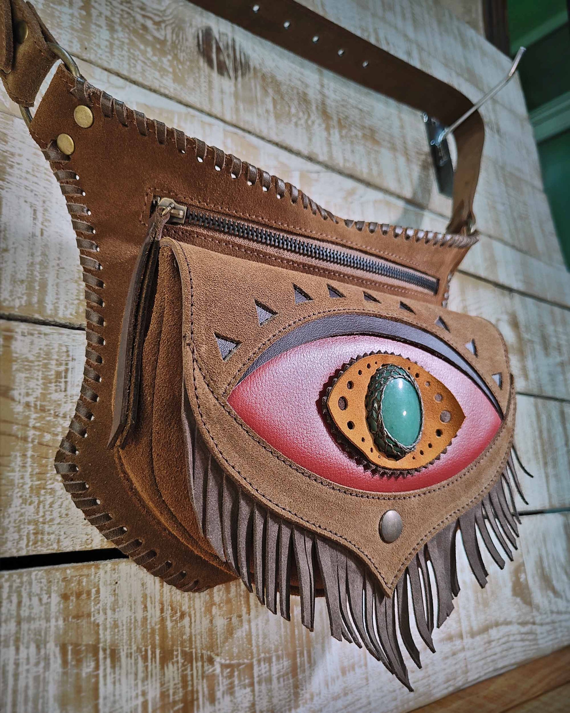 Bohonito Leather festival belt bag model Omara with a red fringed flap, featuring an aventurine stone and hand-laced finish.