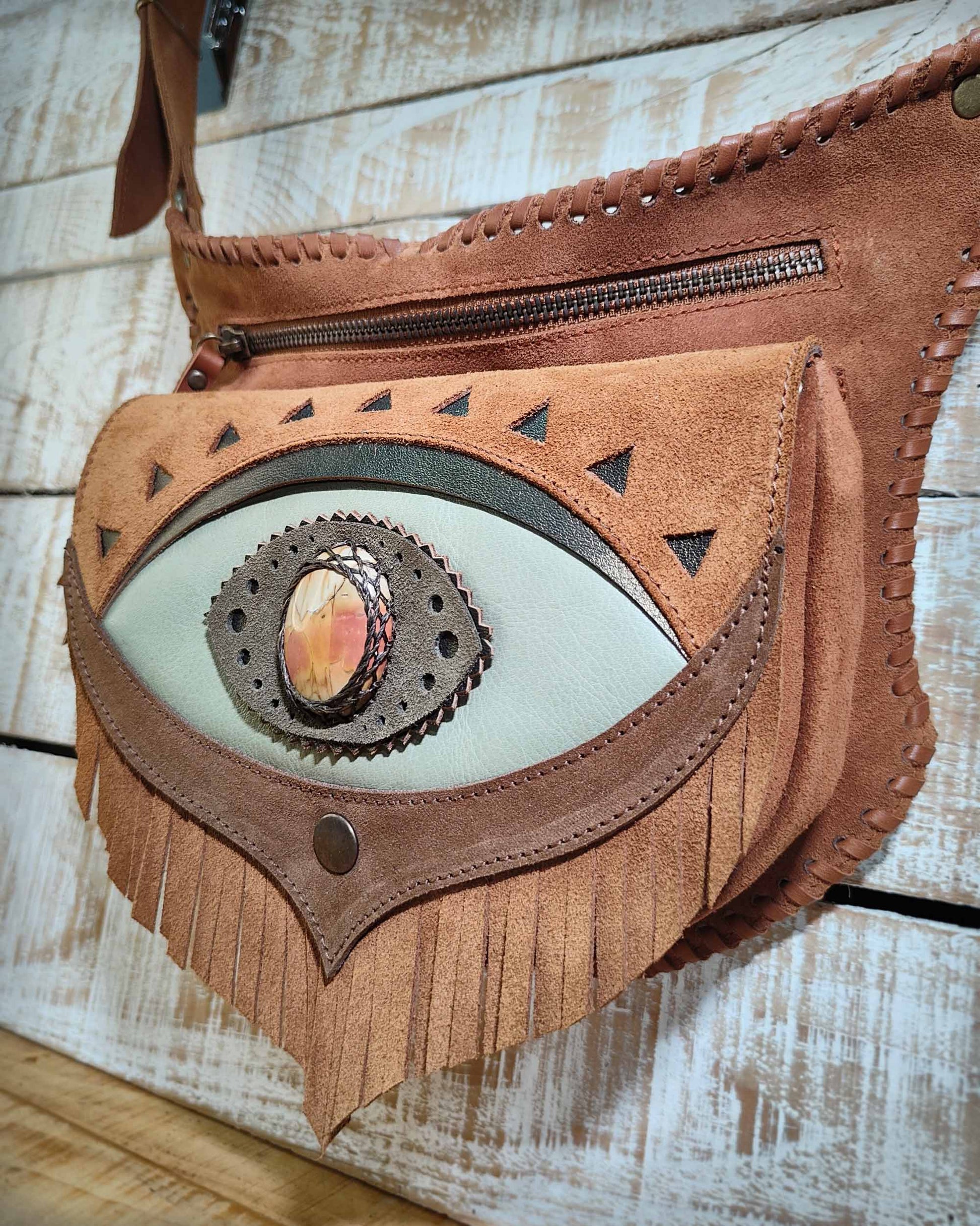 Bohonito Omara brown leather belt bag featuring a seafoam fringe flap, Ajna Chakra design with polychrome  jasper stone, and hand-laced edges.
