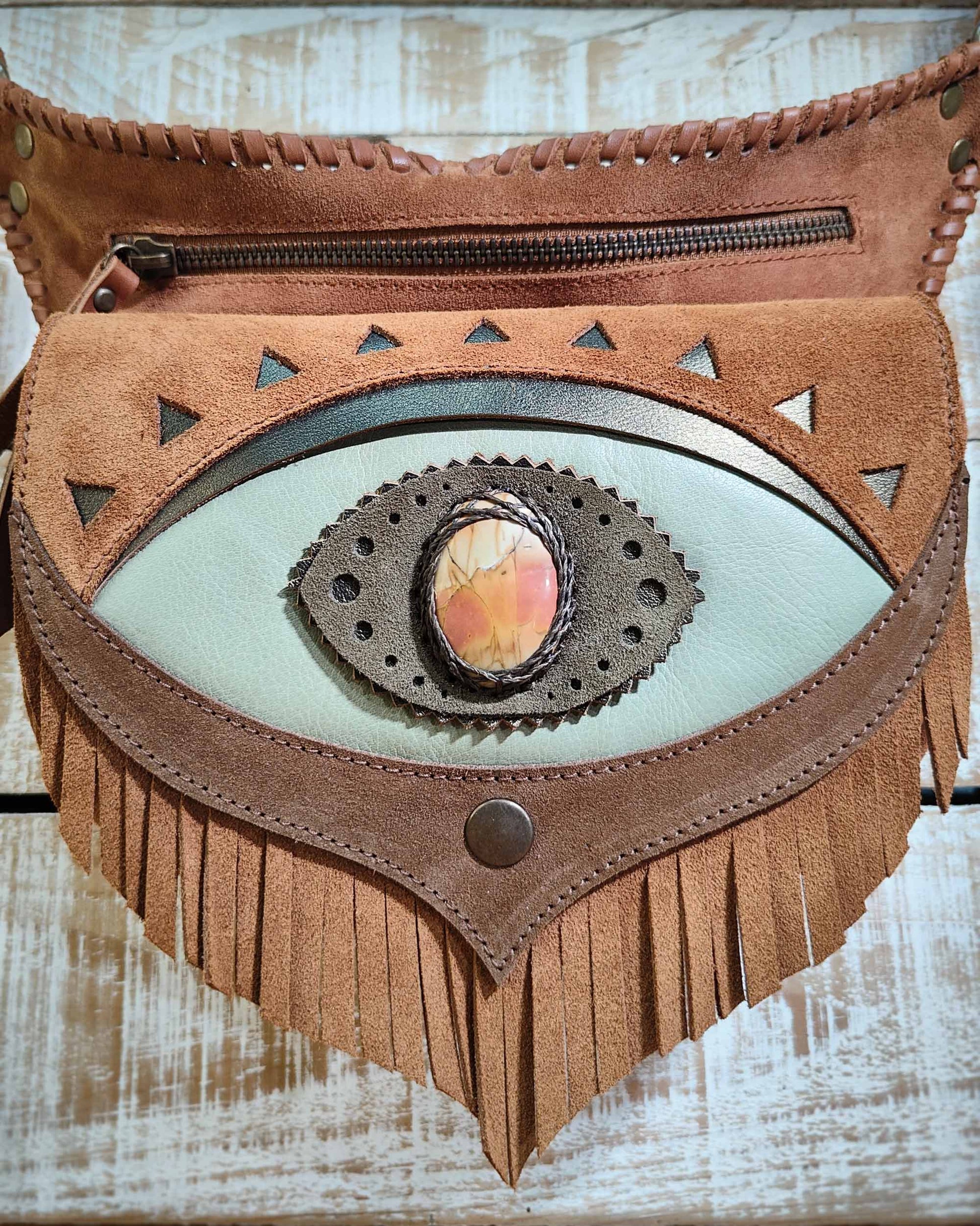 Handcrafted leather belt bag with a seafoam green flap, third eye Ajna detail featuring a polychrome jasper inlay and artisanal leather lacing.