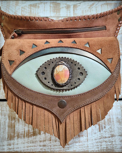 Handcrafted leather belt bag with a seafoam green flap, third eye Ajna detail featuring a polychrome jasper inlay and artisanal leather lacing.