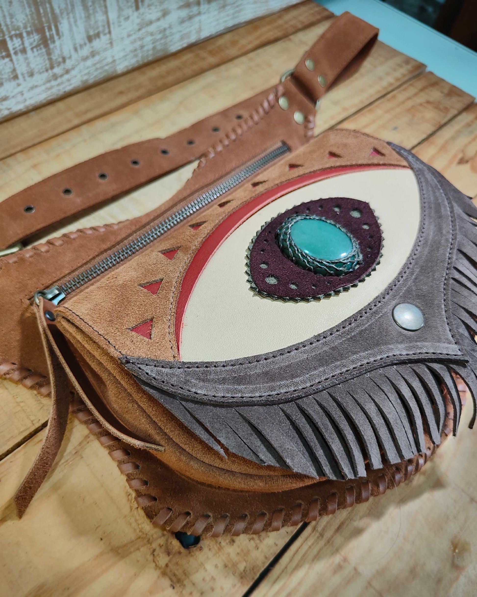 Bohonito Omara brown leather belt bag featuring a cream fringe flap, Ajna Chakra eye design with polychrome jasper, and hand-laced edges.