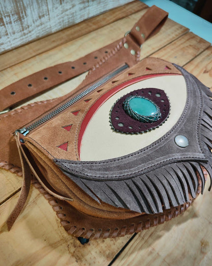 Bohonito Omara brown leather belt bag featuring a cream fringe flap, Ajna Chakra eye design with polychrome jasper, and hand-laced edges.