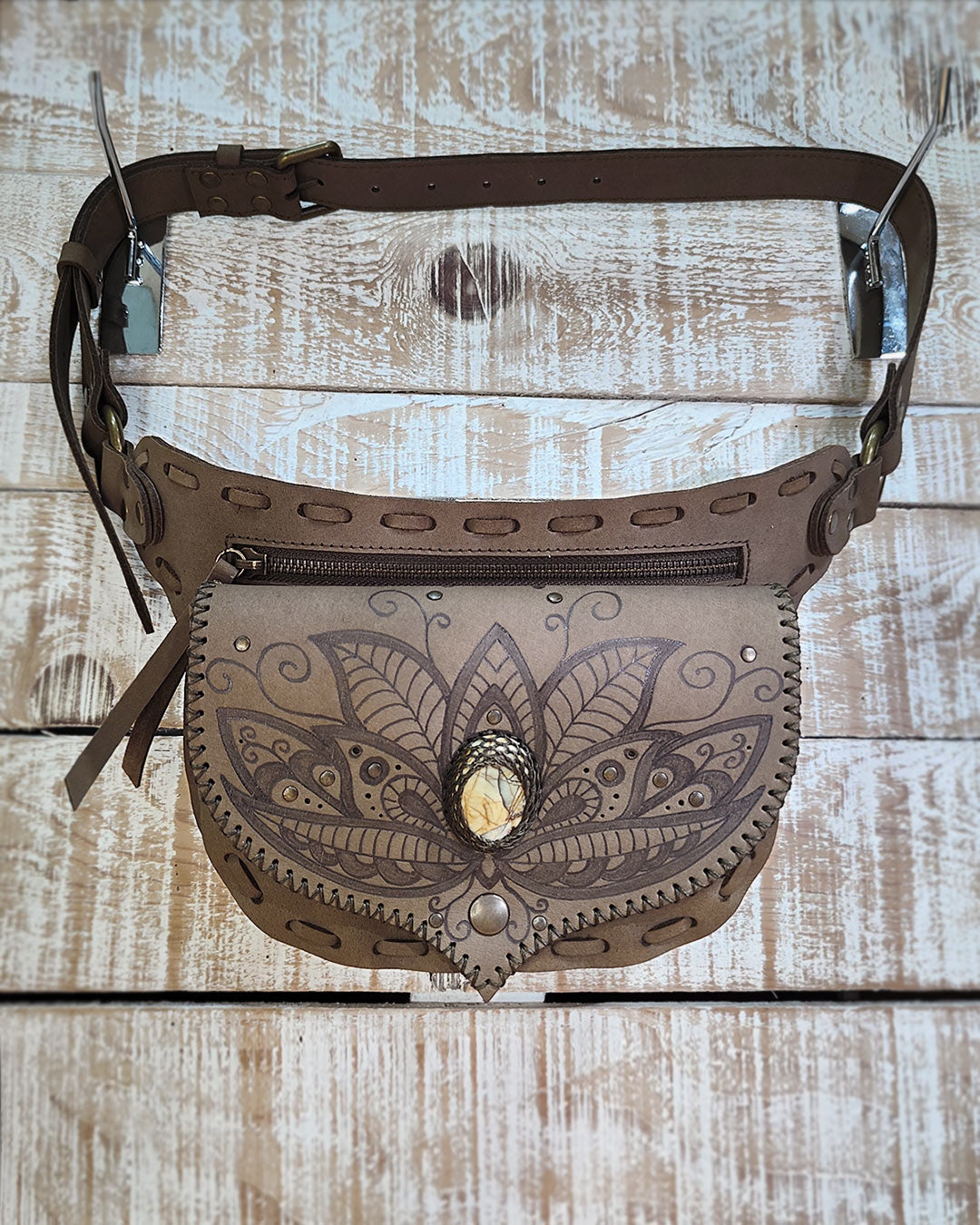 Detailed view of velvety Kaki Nubuck leather on a Bohonito Gautxa belt bag with handcrafted pyrography art.