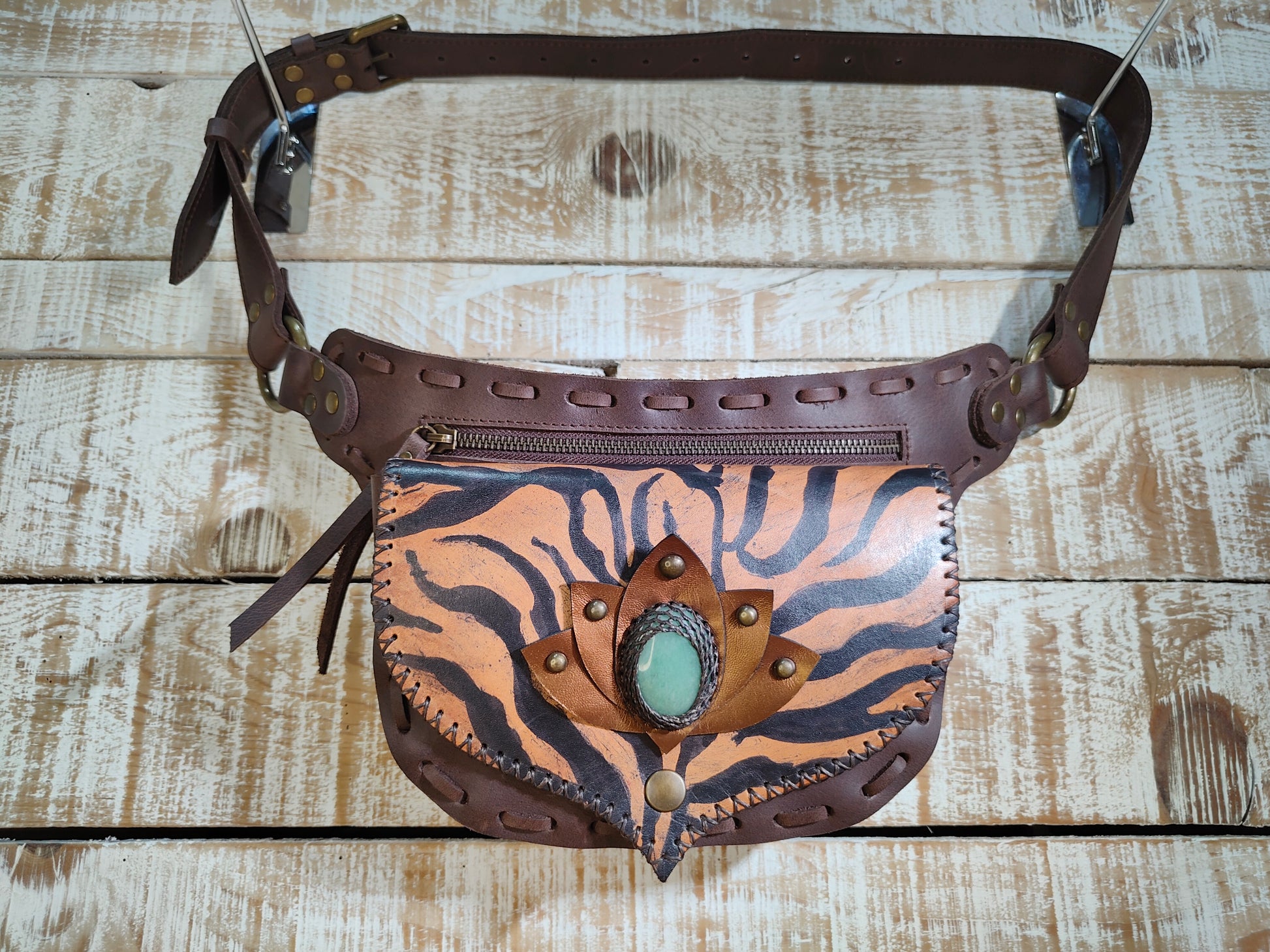 Bohonito gautxa waist bag handcrafted in premium brown buffalo leather with an artistic lotus tiger motif and aventurine stone.