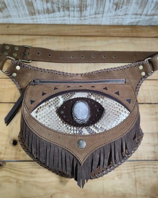 Artisanal belt bag by Bohonito featuring a red 'third eye' fringe flap, natural aventurine stone, and hand-laced leather detailing.